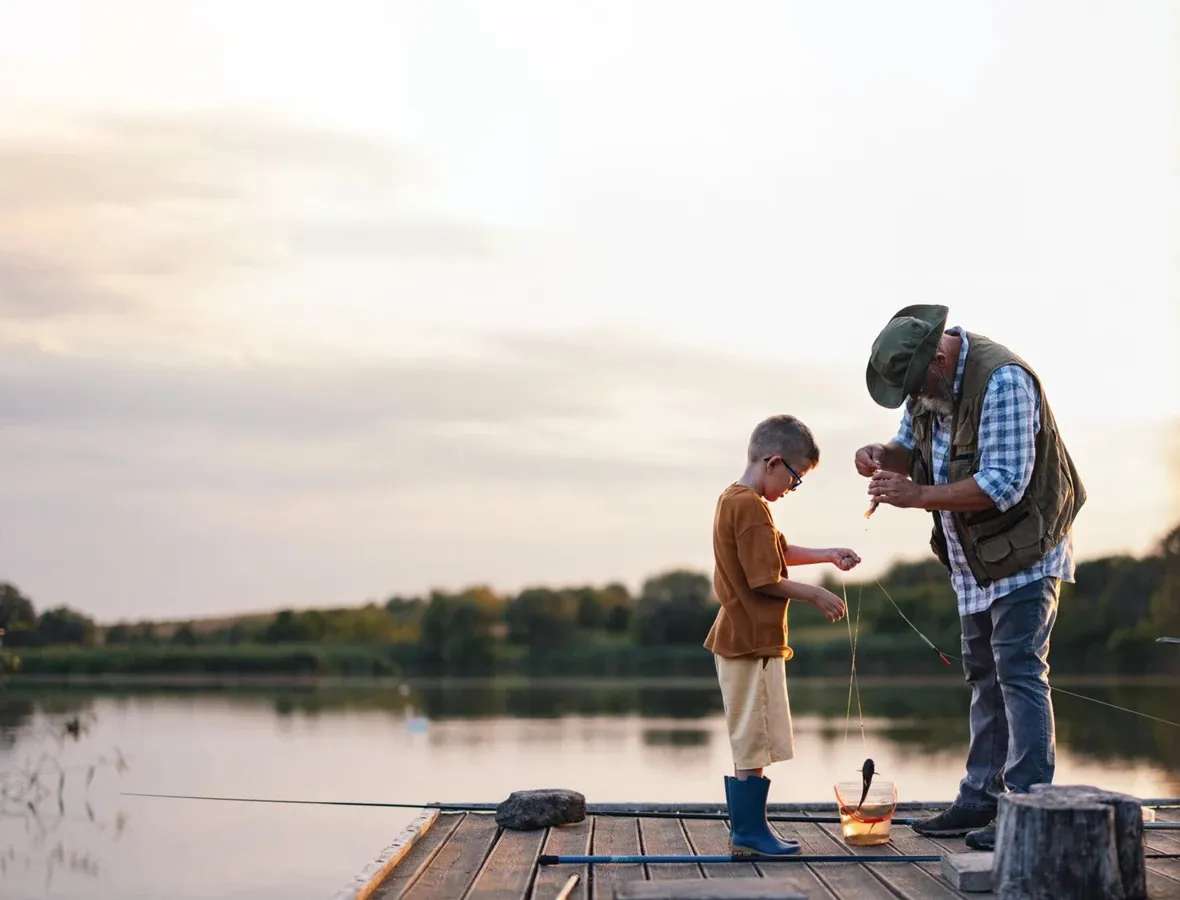 Grandfather and Grandson Fishing on a Dock